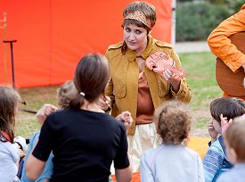 A musician interacting with a group of children